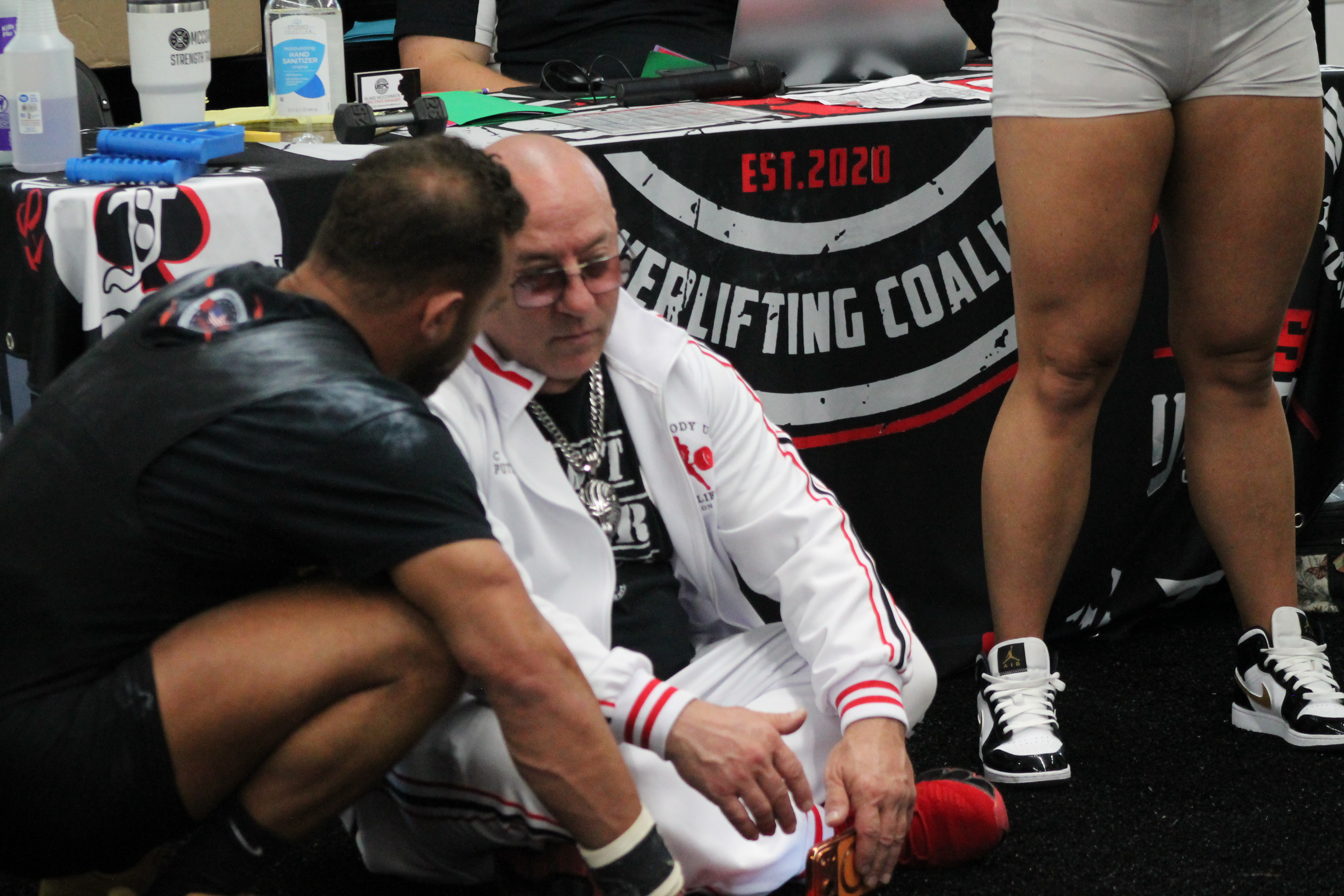 Coach giving guidance on a lifter's next attempt
